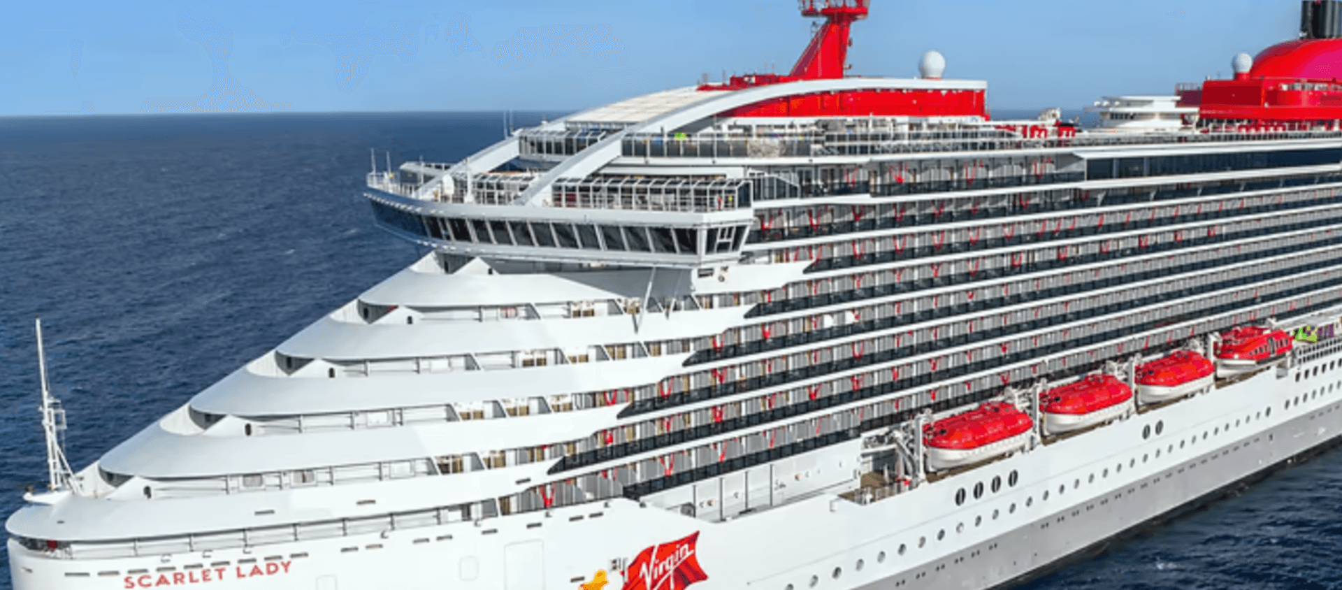 white and red virgin voyages cruise ship on the ocean