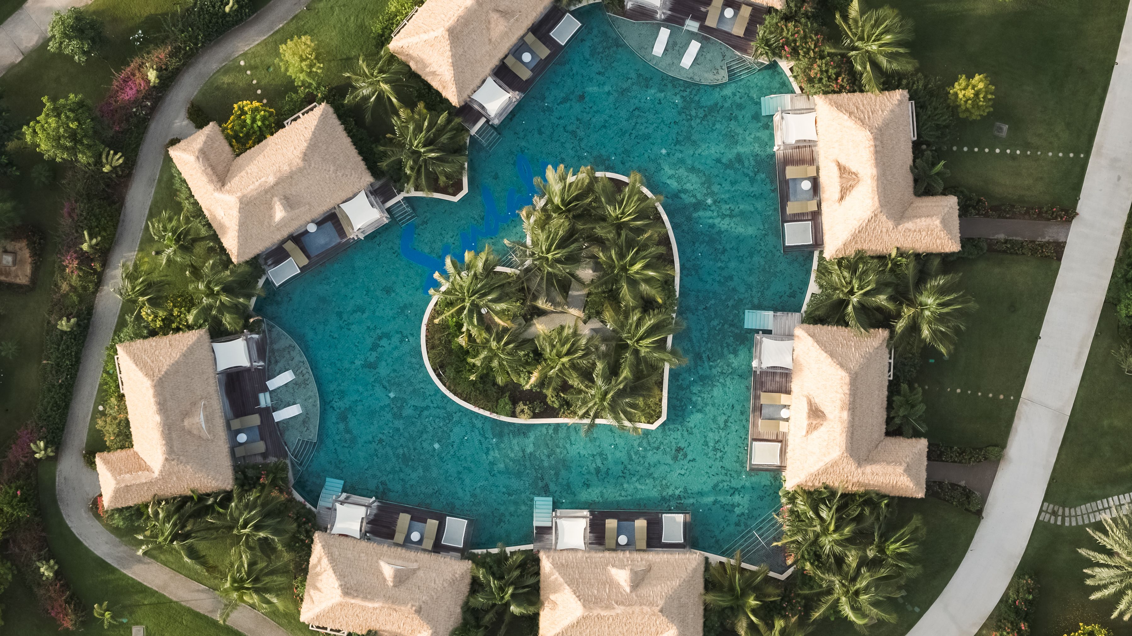 over water bungalows on tropical island shaped like a heart