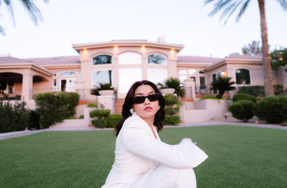 woman in sunglasses standing in front of building