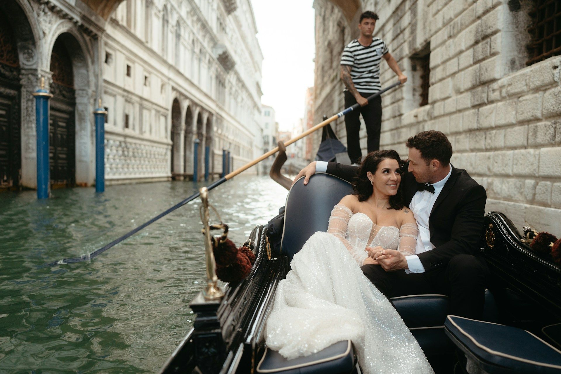 Bride and groom in a river ride through the Venice canals.